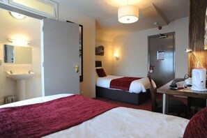 A hotel room with two beds, a desk with a coffee maker, a sink, and a mirror. - Spy Glass & Kettle Hotel (Bournemouth)
