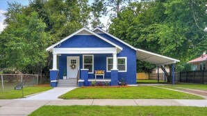 A single-story house with a gabled roof, a front porch, and a small front yard. - Blue Bungalow! Wonderful 4-bedroom house in charming Augusta (Augusta)