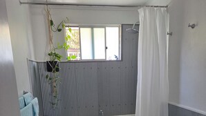 A bathroom with a bathtub, toilet, and a window with a view. - Debs Place Room 2. Peaceful cosy room with your own entrance. (Denmark)