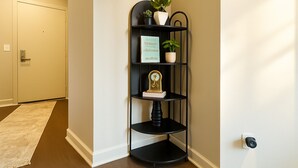 A corner shelf with decorative items and a potted plant. - Chevy Chase 414 3BR (Chevy Chase)