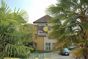Un bâtiment d’hôtel avec une enseigne indiquant « HÔTEL éco Relais PAUL-LUC ».