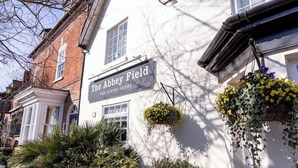 A building with a sign reading 'The Abbey Field Pub-Dining-Rooms.' - Milsoms Hotel (Kenilworth)