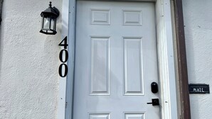 A white door with the number 400, a black mailbox, and a black wall-mounted light fixture. - Historic Downtown Visalia 2BR • 1BA (Visalia)