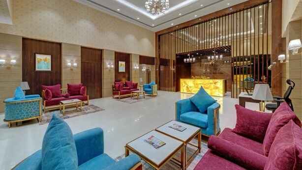 A spacious lobby with seating areas, a reception desk, and a decorative wall. - The Fern Residency Satara Maharashtra (Satara)