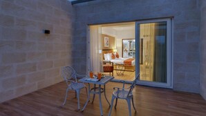 A room with a bed, a table, and two chairs. - The Fern Residency Satara Maharashtra (Satara)