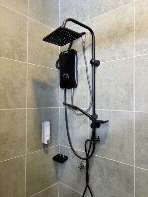 A shower with a handheld showerhead and a control unit mounted on the wall.