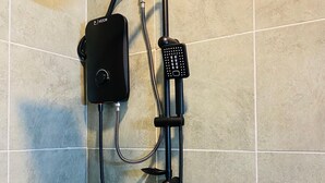 A shower with a handheld showerhead, a handheld massager, and a handheld scrubber. - Modern Studio on Kiambu Rd, Near CBD, JKIA & UN, Walk to Two Rivers/Fast WiFi (Nairobi County)