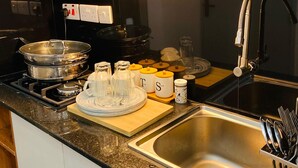 A modern kitchen with stainless steel appliances, a sink, and a variety of utensils. - Modern Studio on Kiambu Rd, Near CBD, JKIA & UN, Walk to Two Rivers/Fast WiFi (Nairobi County)