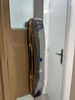 A door with a biometric face recognition lock. - Modern Studio on Kiambu Rd, Near CBD, JKIA & UN, Walk to Two Rivers/Fast WiFi (Nairobi County)
