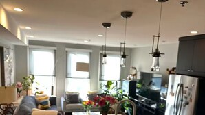 A modern kitchen with a central island, stainless steel appliances, and pendant lighting. -  Hoboken Grand House- 3 Bedroom 2.5 Bathroom with a private rooftop (Hoboken)