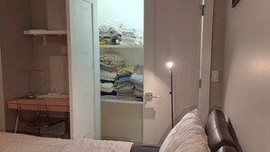 A bedroom with a bed, a desk, and a walk-in closet. -  Hoboken Grand House- 3 Bedroom 2.5 Bathroom with a private rooftop (Hoboken)