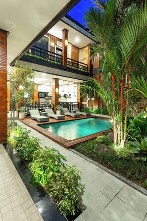 A two-story building with a swimming pool, outdoor seating, and lush greenery. - The Vials Canggu  (Tibubeneng)
