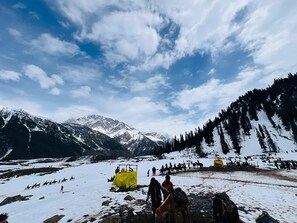 A snowy landscape with tents and people, likely a campsite. - Hotel Ilhan Sonamarg (Sonamarg)