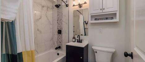 Shower, hair dryer, towels, shampoo