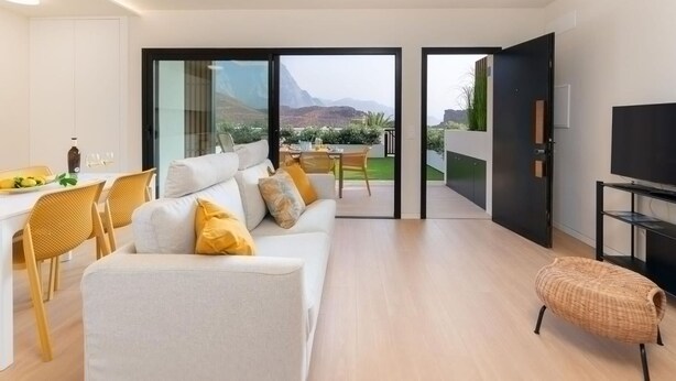 A modern living room with a sofa, chairs, a dining area, and a TV. - Vivelorural Agaete Great Garden (Agaete)