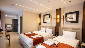 Een hotelkamer met twee bedden, een bureau en een stoel.