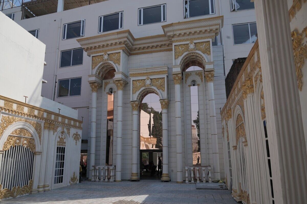 A building with classical architecture, featuring columns and arches.