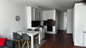 Eine moderne Wohnung mit Essbereich, Küche und Wohnraum.