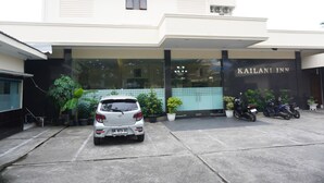 A building with a sign reading 'KAILANI INN' and a parked car in front. - Siantar Hotel Parapat (Medan)