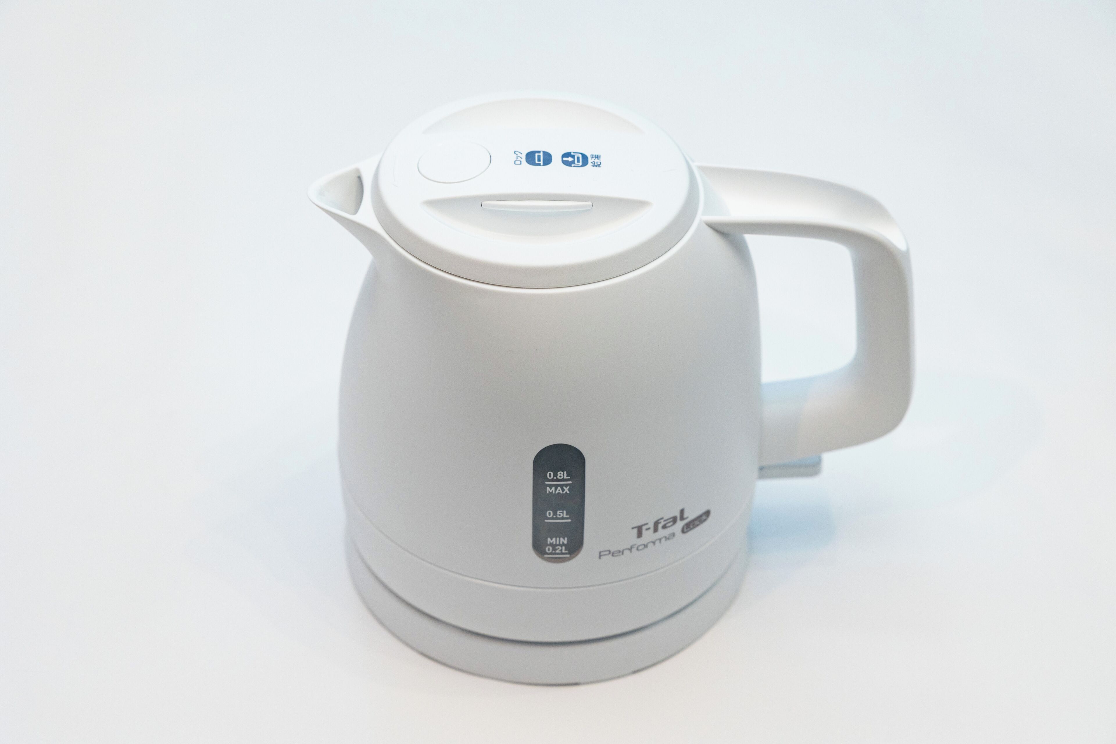 A white electric kettle with a handle and a control panel.