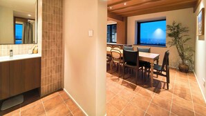 A modern hotel room with a bathroom, a dining area with a city view, and a large window. - Stylish Homestay Balcony View Bell Tower (Xi'an)