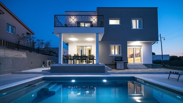 A modern two-story house with a swimming pool, outdoor seating, and a balcony. - Villa IviCasa with pool (Murvica)