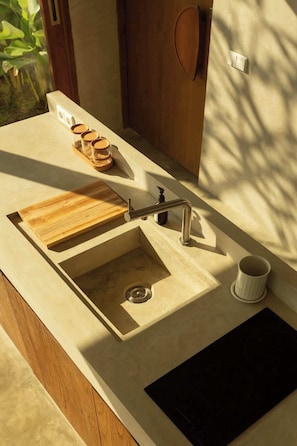 A bathroom with a wooden vanity, a sink with a modern faucet, and a cup holder. - Modern Retreat, Pool & Mt Agung View (Nusa Lembongan)