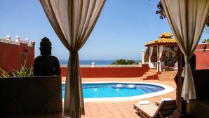 A pool area with a view of the sea, a Buddha statue, and a gazebo. - Villa Zen Adeje - Private Heated Pool (Adeje)