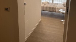 A hotel room with a bed, a bedside table, and a window with curtains. - HOTEL VILLA MARY (Santa Maria di Sala)