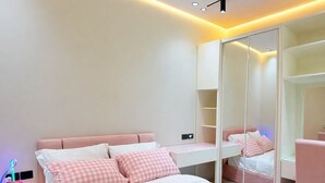 A modern bedroom with a bed, bedside tables, a wardrobe, and a mirror. - 5 Rooms with private garden& Jacuzzi& Pool acc (New Administrative Capital)