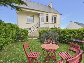 A house with a stone staircase leading to a door, a small patio with a table and chairs, and a well-maintained garden. - 450m from the beach, suitable for 2 adults/2 child (Brignogan-Plage)