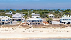 A coastal residential area with beachfront properties, a bridge, and a distant tower. - Getaway Beach Front, St. George Island Private 4  Bedroom Home (St. George Island)