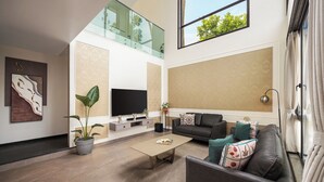 A modern living room with a flat-screen TV, a sofa, a coffee table, and a potted plant. - Cloud 7 by ELIVAAS Luxurious 4 BHK Villa (Vagator)