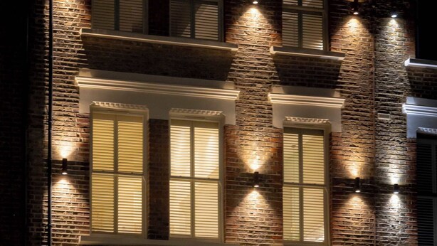 A multi-story building with brick facade, multiple windows, and a central entrance with a red door. - Premium Studio 15 at The Orange Door Little Venice (Greater London)