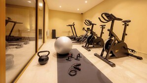 A gym with exercise equipment, a large exercise ball, and a yoga mat. - Standard Studio 6 at The Orange Door Little Venice (Greater London)