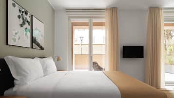 Una camera d'albergo con un letto, una televisione e vista sull'esterno.