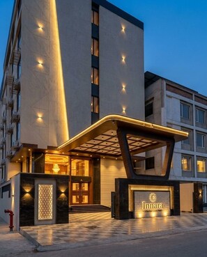 A hotel entrance with a modern design, featuring a prominent entrance canopy and illuminated signage. - Innara - A Boutique Luxury Hotel (Jaipur)