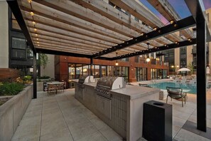 An outdoor patio with a barbecue area, pool, and seating. - Elevated Downtown SLC Stay - Pool + Sauna Retreat (Salt Lake City)