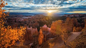 A canyon landscape with distinctive rock formations and a clear sky. - Red Canyon Village (Panguitch)