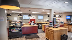 A restaurant with a counter, seating area, and vending machines. - Red Canyon Village (Panguitch)