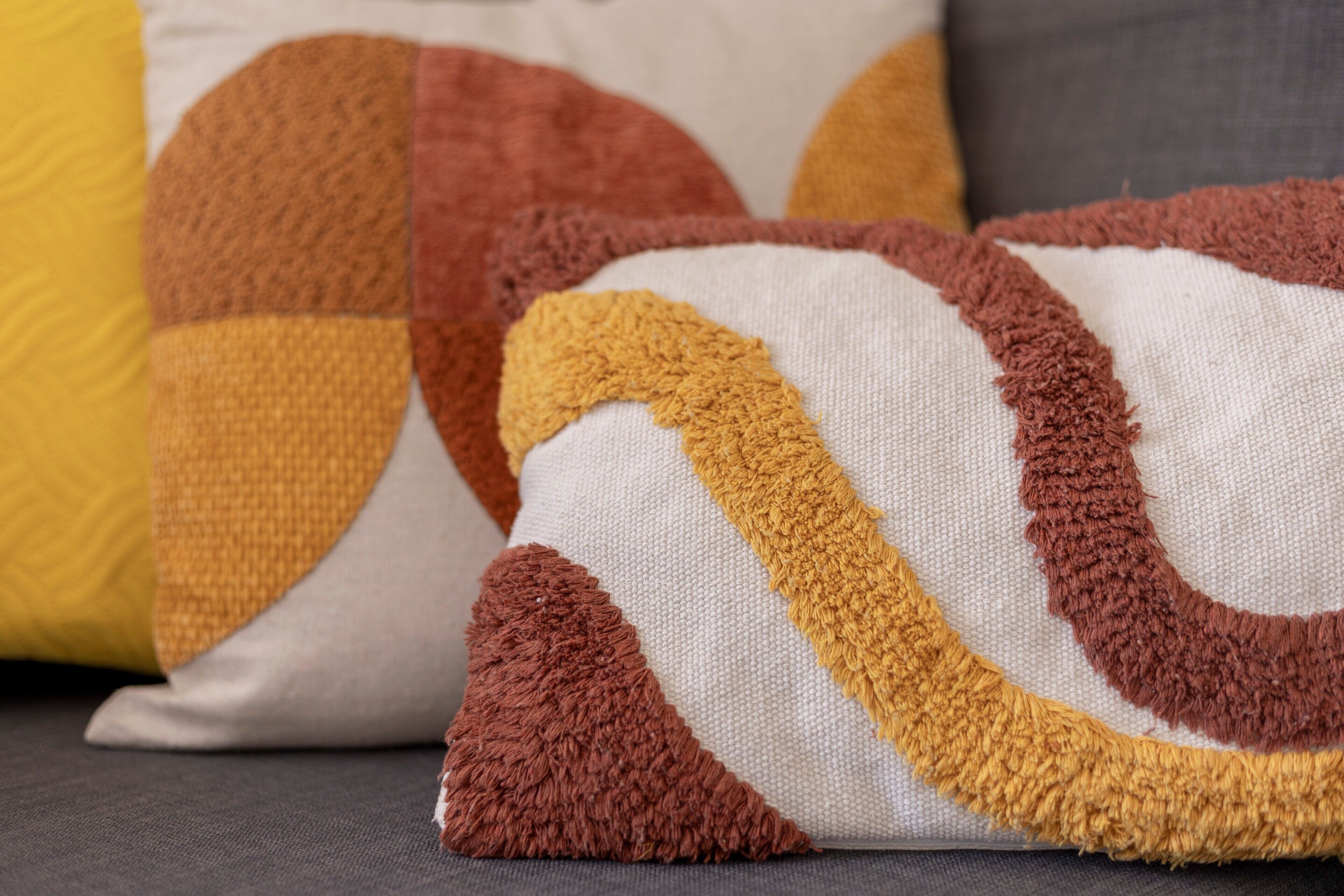 A close-up of a sofa with patterned cushions.