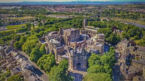 An aerial view of a historic castle surrounded by greenery and modern buildings. - Riverside House, Lancaster (Lancaster)