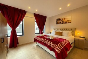 A hotel room with a bed, curtains, a painting, and a nightstand. - Lange Leemstraat Gem near Station (Antwerpen)