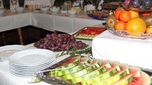 A buffet table with various fruits and sliced watermelon.
