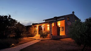 Une maison moderne dotée d’un porche abrité, d’une cheminée en briques et d’une antenne parabolique.