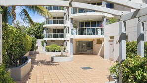 A modern multi-story building with balconies, a central courtyard, and surrounding greenery. - Riviera 102: 2  BR, 2  BA Apartment in Port Macquarie, Sleeps 4 (Port Macquarie)