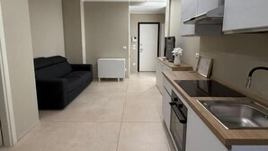 A modern kitchen with a built-in oven, a sink, and a countertop.