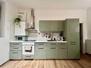 A kitchen with a microwave, stove, sink, and cabinets. - Historic Apartment near center + Free Parking (Como)