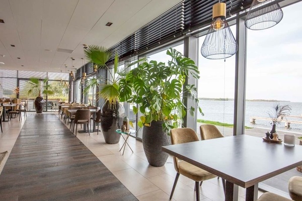 Unwind by panoramic windows while savoring relaxed coastal dining.