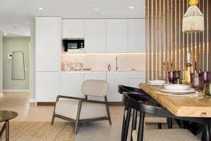 A modern kitchen with white cabinets, a built-in microwave, and a coffee maker on the countertop. - Boutique Apt | Golf, Sea & Mtn Views | Pool, Sauna & Gym | Mijas Costa (Bloque 1, Piso 2, Escalera 1, Puerta C)